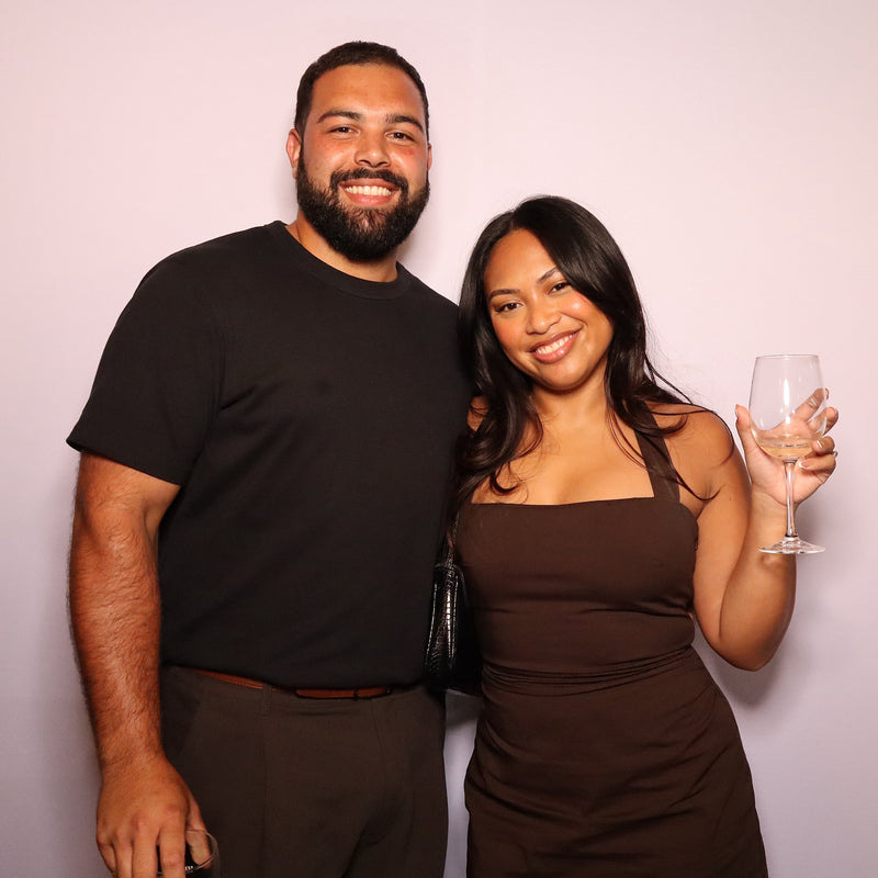 girl and guy posing holding wine glass