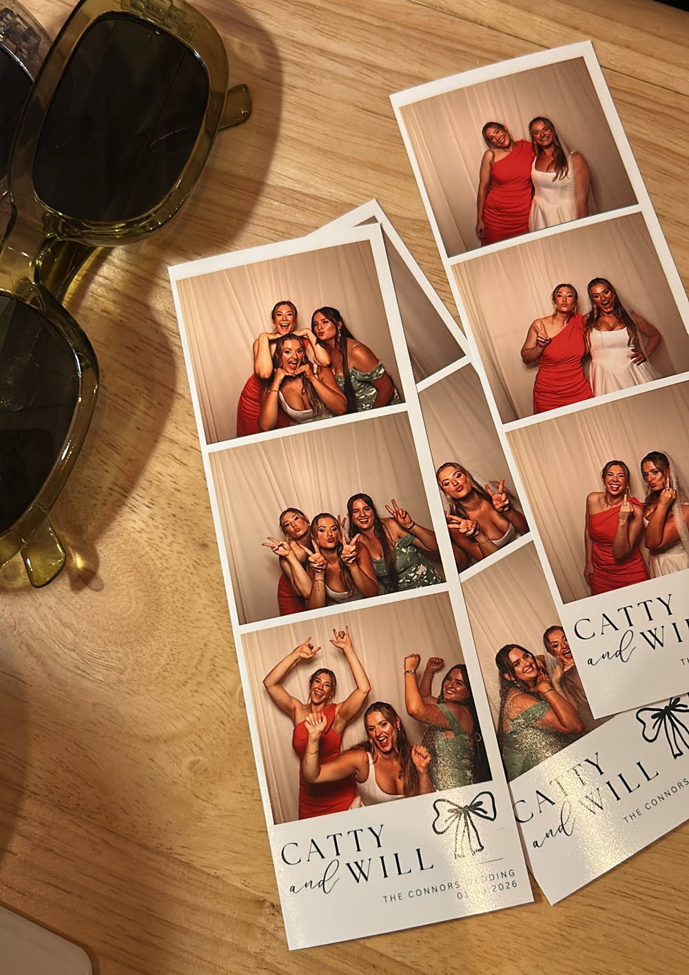Strips of paper with multiple photos and 'Catty and Will' branding on a wooden surface.